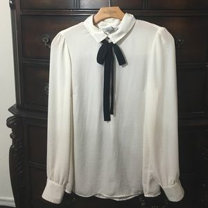 H&M cream long sleeve blouse with black tie.