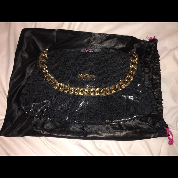 Betsy Johnson black clutch with gold chains.