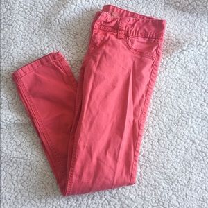orange-y red cropped skinny jeans