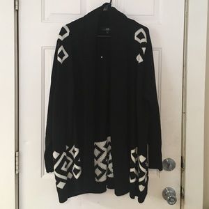 Open black sweater with white designs