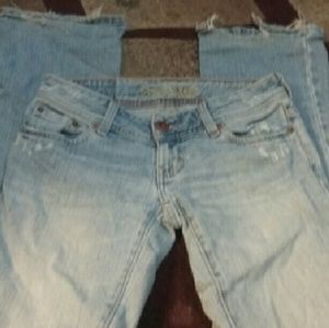 Light wash jeans some fringe coming off the bottom