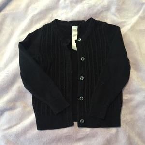 Black ribbed cardigan seater with clear button detail.