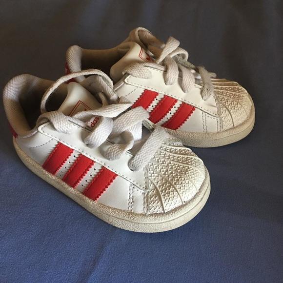 White Adidas with red stripe