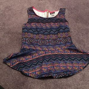 Colorful peplum top with back zipper accent