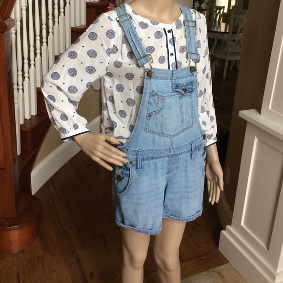 Light blue denim overalls.