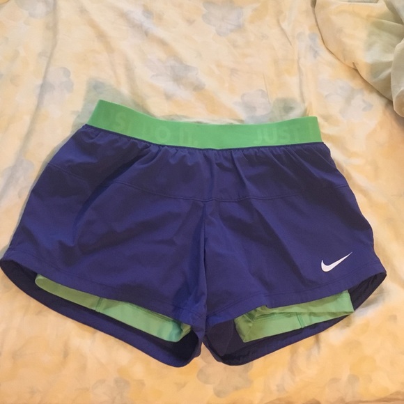 Purple and green Nike running shorts