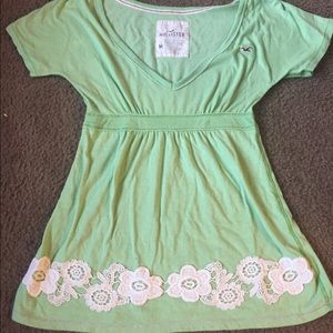 Green v-neck Hollister top with lace bottom.