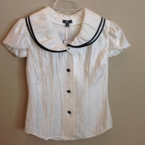 Brand new ivory blouse with black trim.