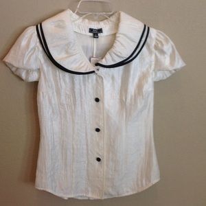 Brand new ivory blouse with black trim.
