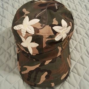 Camouflaged hat with white flowers never worn.