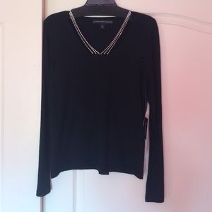 Black sweater with rhinestones at neckline.