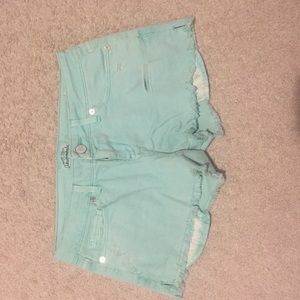 Ripped turquoise jean shorts