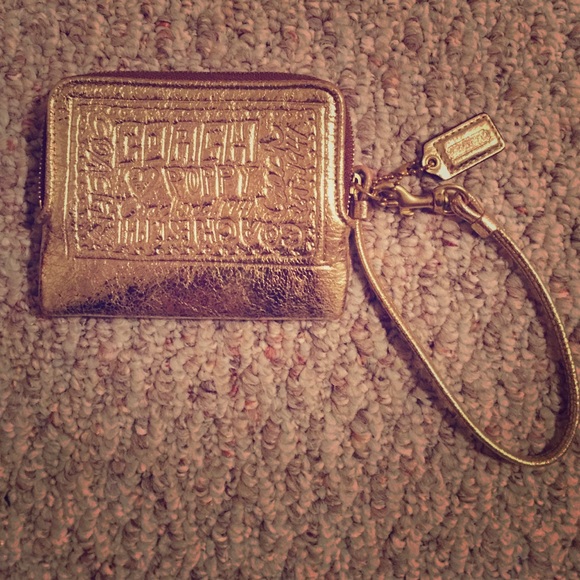 Gently used Coach wristlet in metallic gold