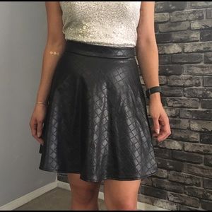 Black vegan, quilted mini skirt.