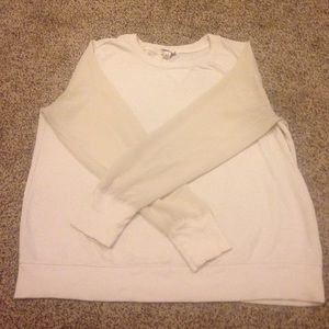 Cream sweater, with sheer sleeves.