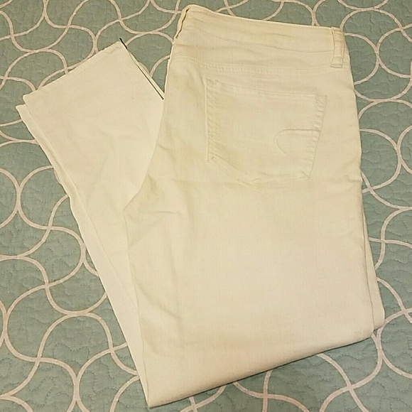 White ankle jeggings, with zippers.