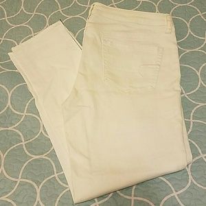 White ankle jeggings, with zippers.