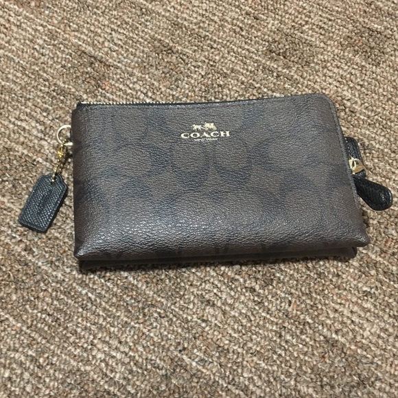 Dark brown and black signature Coach wristlet.