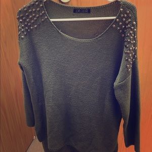 Green sweater with ash grey studs on the shoulders