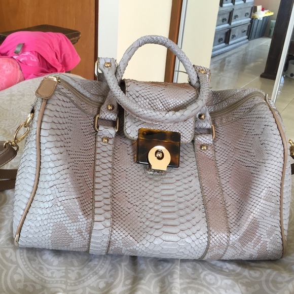 Faux snakeskin small duffle handbag.