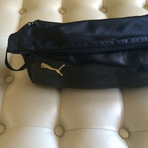 Black puma zipper cleat bag.