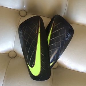 Lime neon green, gray, black nike shin guards .