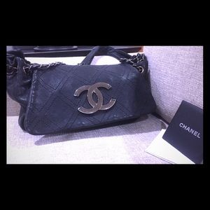 CHANEL classic black leather bag.