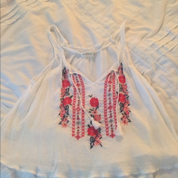 White tank with embroidered flowers.