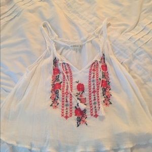White tank with embroidered flowers.