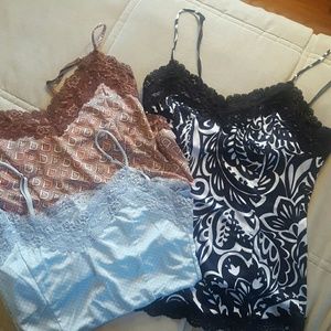 3 silky camisoles. Lace trim on top and bottom.