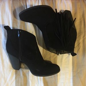 Black heeled booties with fringe