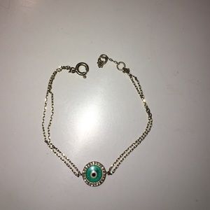 Evil eye bracelet. Light blue and gold