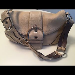 Cream colored Coach purse