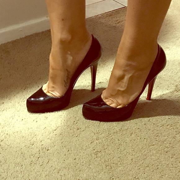 Christian loubs shoes (holding)