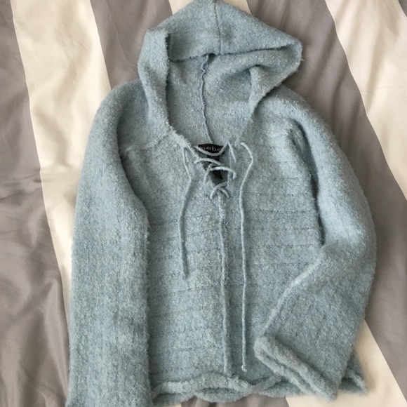 Blue sweater with crisscross tie opening