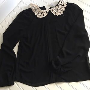 Sheer black blouse with crocheted color.