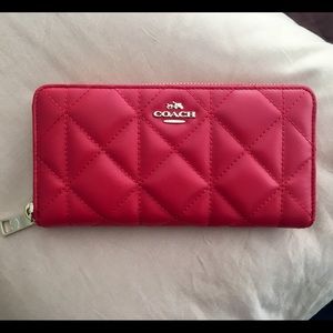 Coach red, quilted leather wallet.