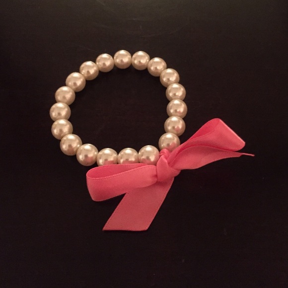 Faux pearl bracelet with pink ribbon