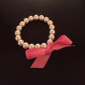 Faux pearl bracelet with pink ribbon