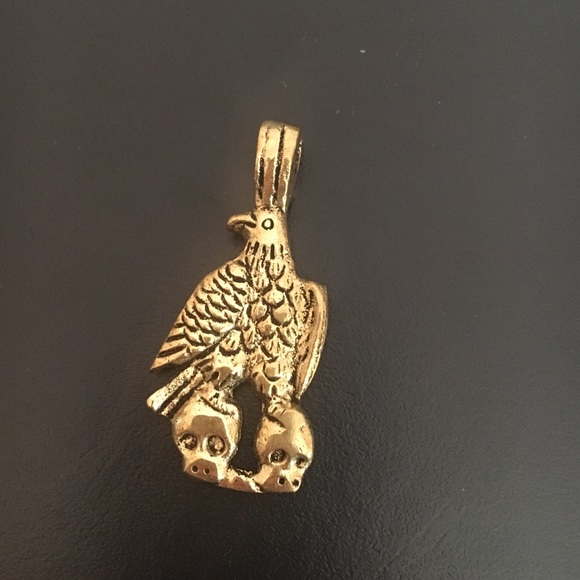 Gold plated Eagle carrying skulls pendant