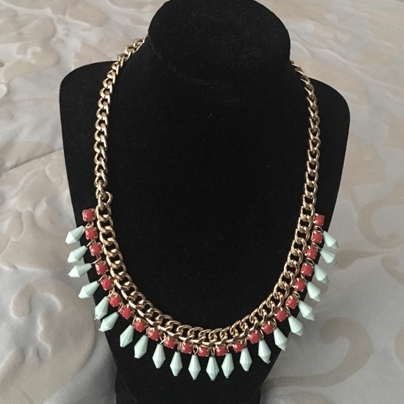 Gold tone chain and jeweled necklace