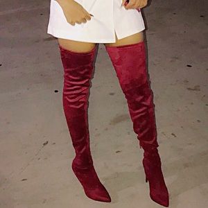 Burgundy thigh high skinny heel boots.
