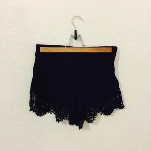 Black shorts with lace trim.