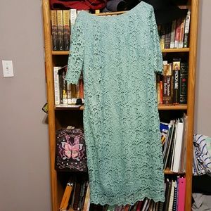 A teal colored lace dress