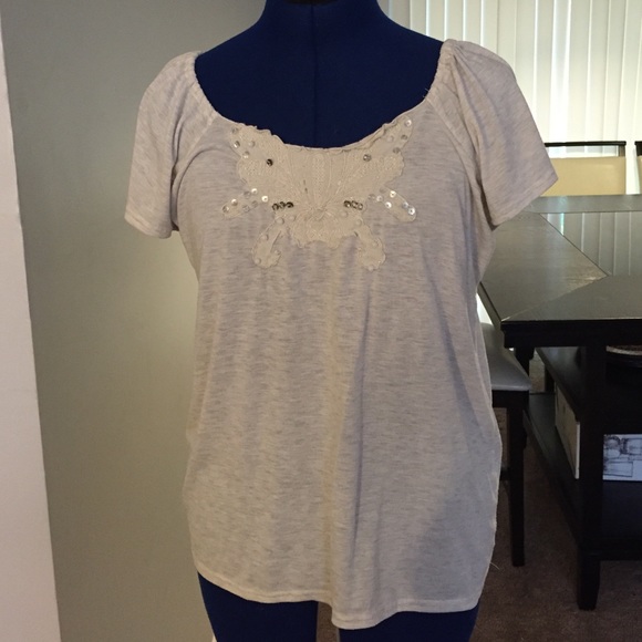 Tan blouse with tie back.