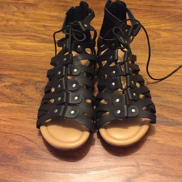 Black gladiator flats.