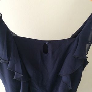 Navy sleeveless mini-dress with sheer overlay