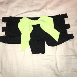 Black cut out booty shorts with neon green bow