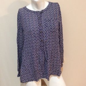 A long sleeved patterned blouse.
