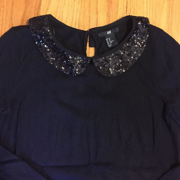 Black sweater with sequin trimm collar. NWOT